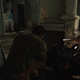 A four-way UI element shows different inventory options as Joel crouches over dead bodies in The Last of Us.